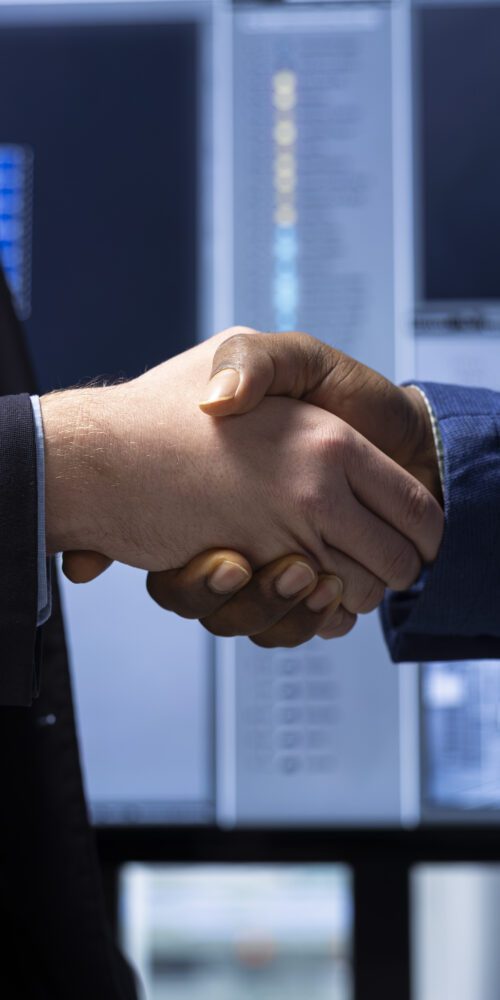 Investor shaking hands with factory manager after finding no issues closeup
