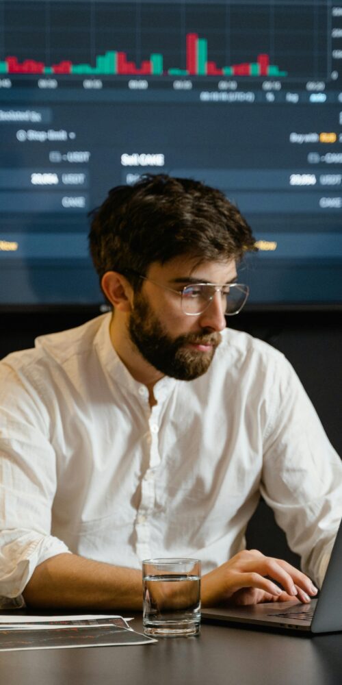 Man in White Dress Shirt Using Laptop